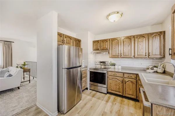 a kitchen with a stove sink and cabinets