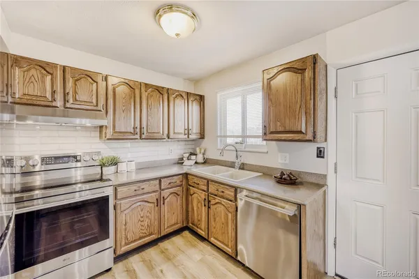 a kitchen with a sink cabinets and window
