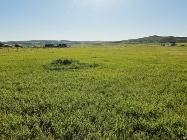 1720 Lower Bern Road, Unit 8 Bern, ID 83220 - Photo 3 of 7 Expansive green field with distant rolling hills and a clear sky