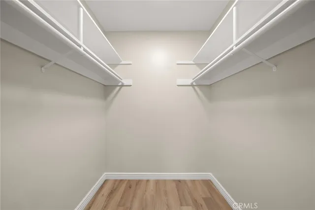 a view of walk in closet with empty racks