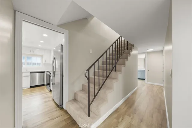a view of entryway and hall with wooden floor