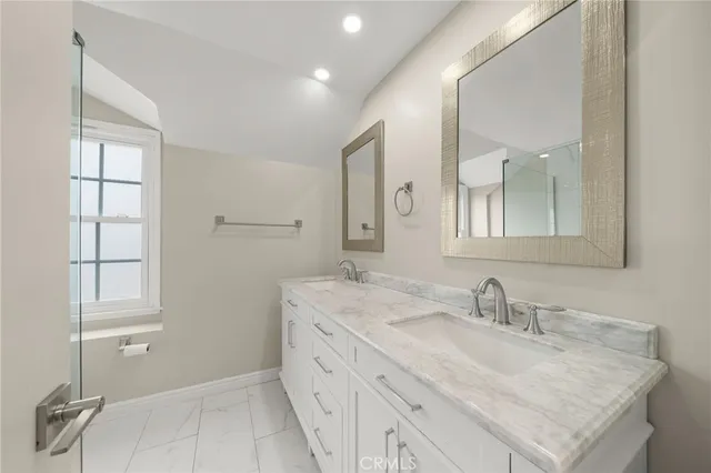 a bathroom with a sink double vanity and a mirror