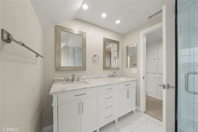 a bathroom with a granite countertop sink mirror and double