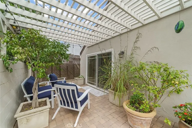 a building outdoor space with patio furniture and potted plants