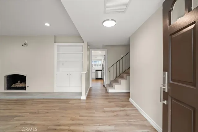 a view of entryway and hall with wooden floor