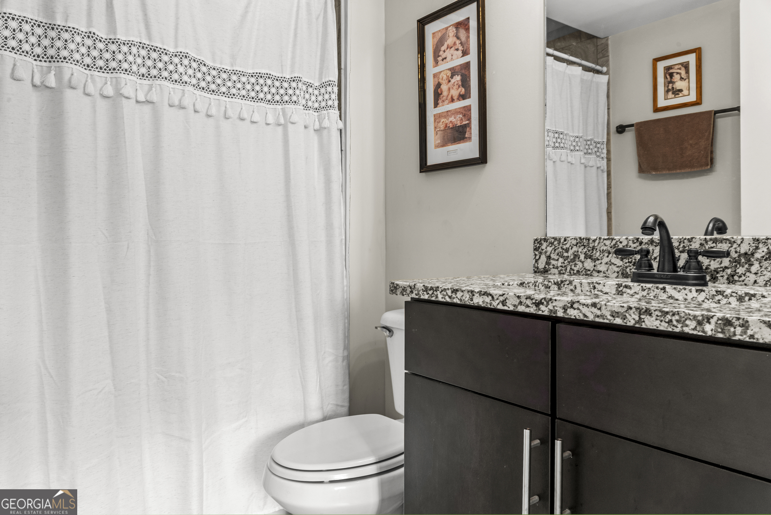 370 Park Street, Unit 8 Madison, GA 30650 - Photo 14 of 22 a bathroom with a granite countertop sink and a toilet