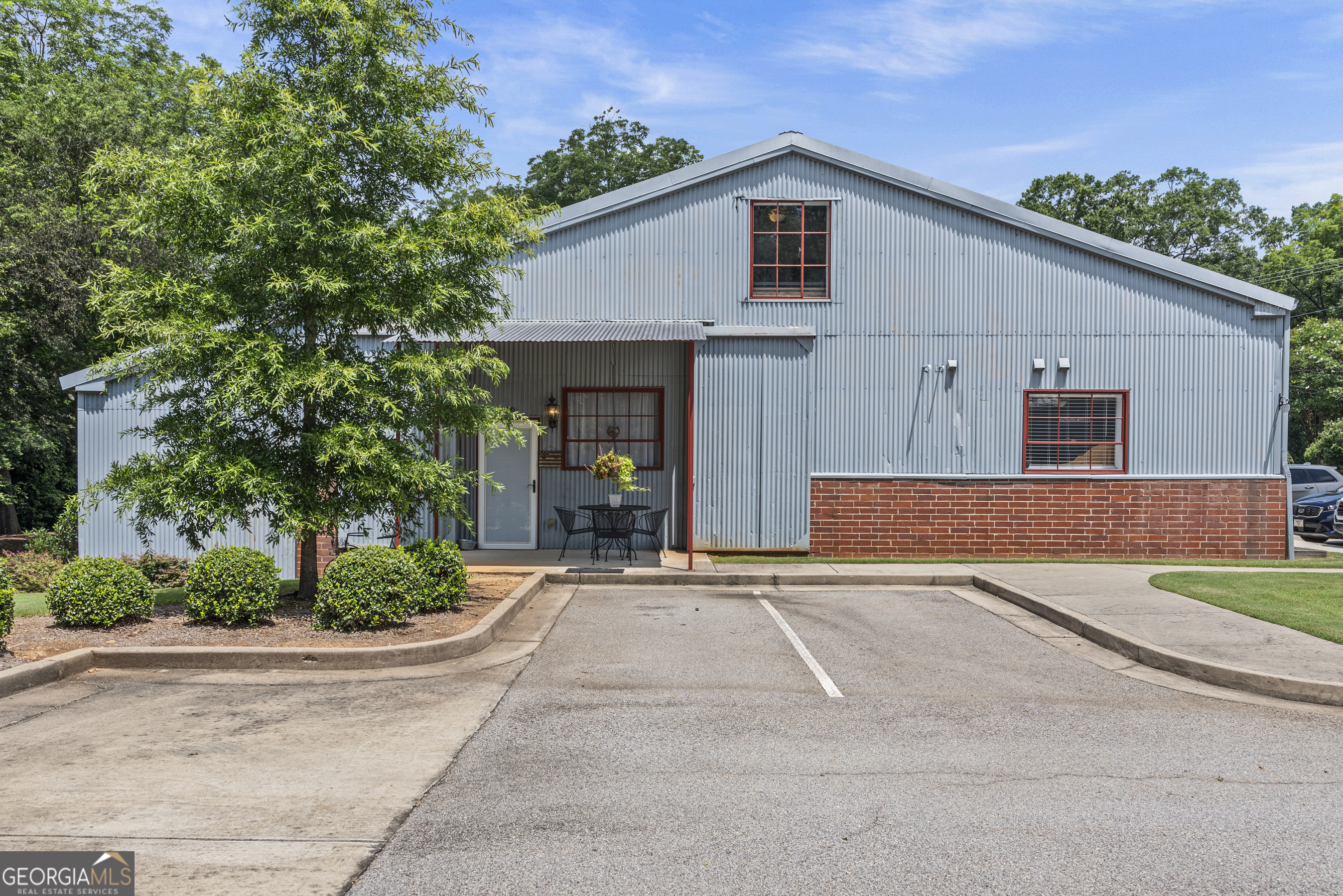 370 Park Street, Unit 8 Madison, GA 30650 - Photo 15 of 22 a front view of a house with a yard and potted plants