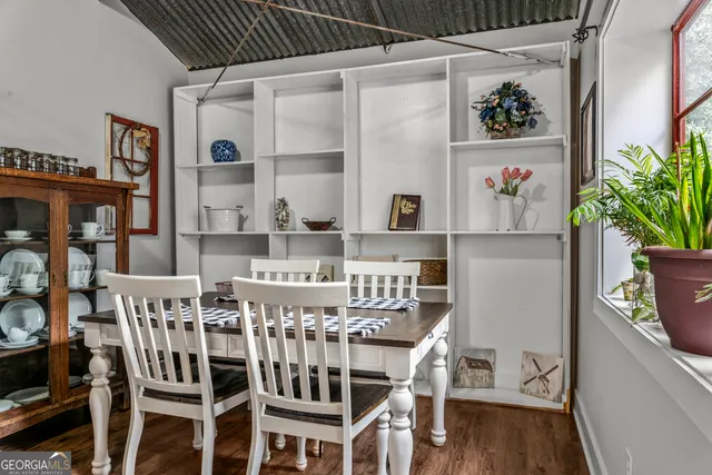 a view of a dining room with furniture and a potted plant