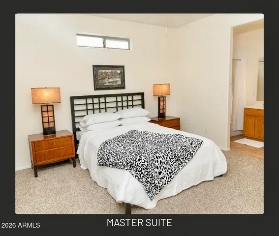 a bed sitting in a bedroom next to a window