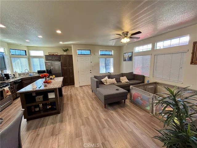 a view of a hallway with wooden floor and a bathroom