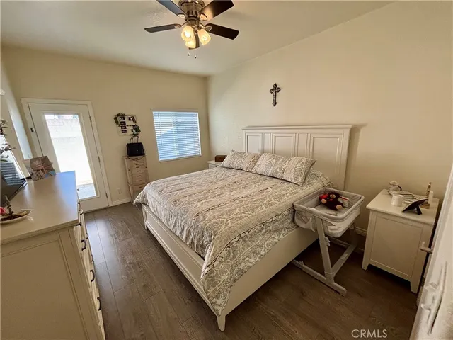 a bedroom with a bed and a flat tv screen on dresser