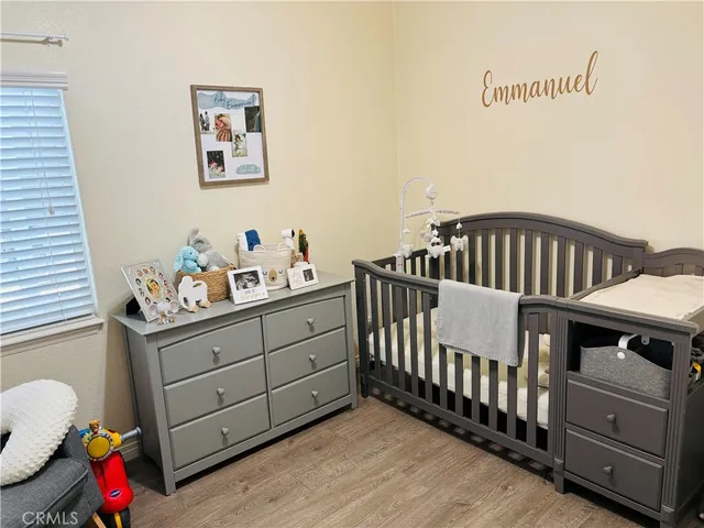 a bedroom with a bed and a ceiling fan