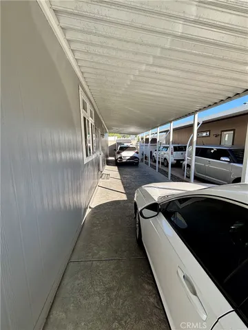 a view of a livingroom with wooden floor and a ceiling fan