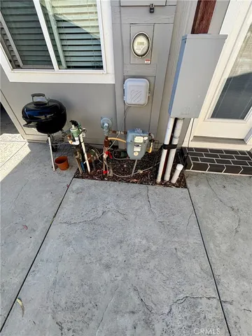 a room with water heater and wooden cabinets