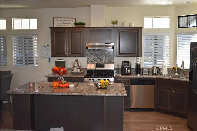 a kitchen with a sink and wooden cabinets