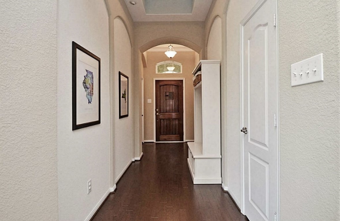1447 Ralston Branch Way Sugar Land, TX 77479 - Photo 3 of 21 From the front door, the interior unfolds in quiet elegance, grounded by warm wood floors and framed by graceful arches. A convenient mud room sits just off the entry.