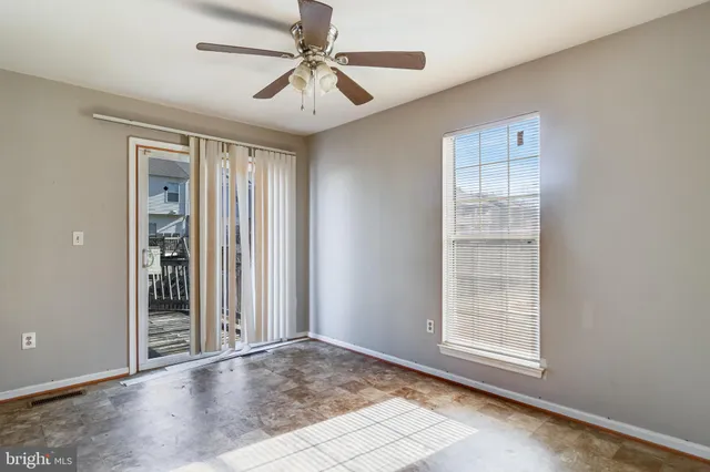 an empty room with windows and closet