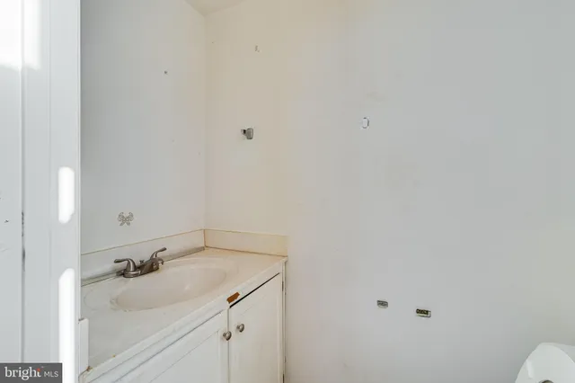 a bathroom with a sink and cabinets