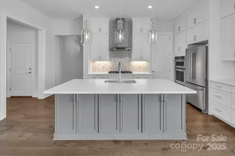 a kitchen with stainless steel appliances a refrigerator and cabinets