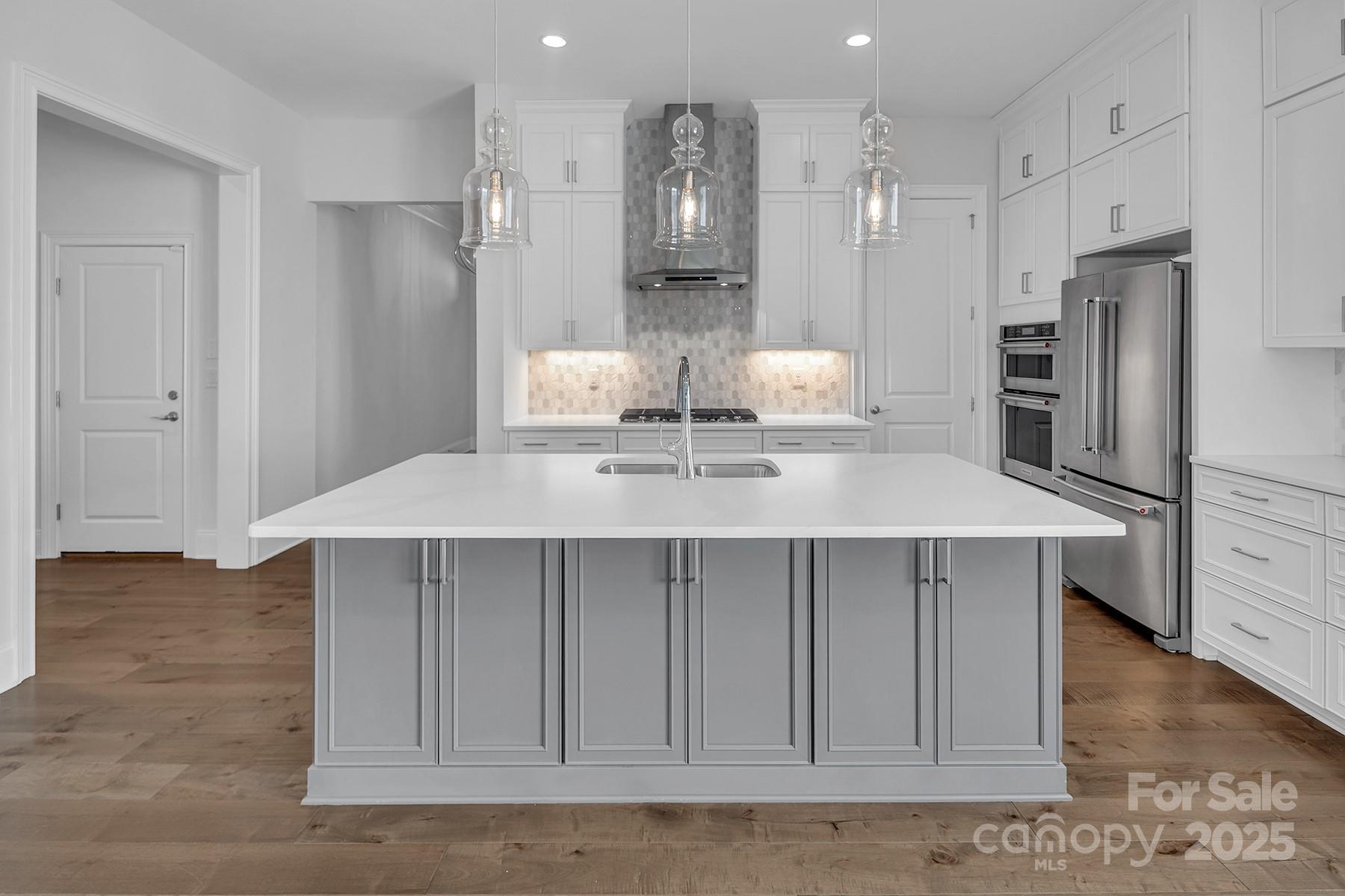 14008 Little Spring Court Charlotte, NC 28278 - Photo 12 of 44 a kitchen with stainless steel appliances a refrigerator and cabinets