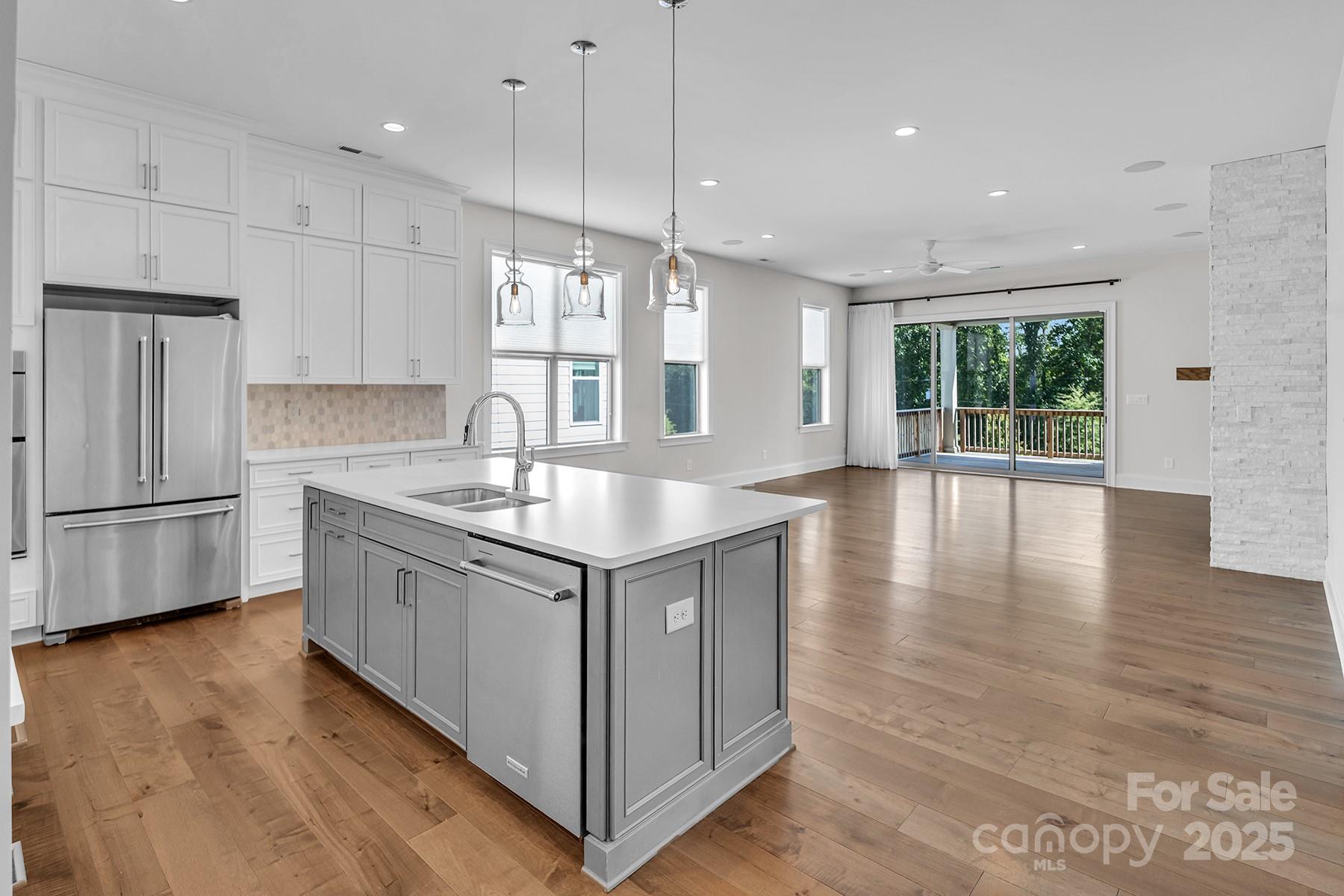 14008 Little Spring Court Charlotte, NC 28278 - Photo 16 of 44 a kitchen with stainless steel appliances granite countertop a sink a window and wooden floor
