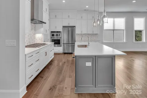 a kitchen with cabinets and wooden floor