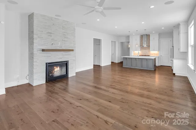 a view of a kitchen with a sink and a fireplace