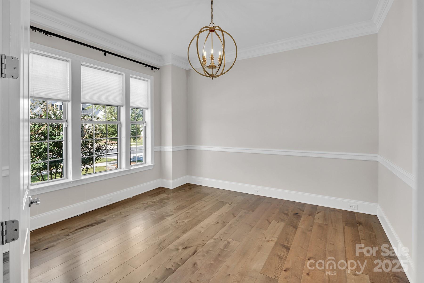 14008 Little Spring Court Charlotte, NC 28278 - Photo 22 of 44 a view of a big room with wooden floor and windows