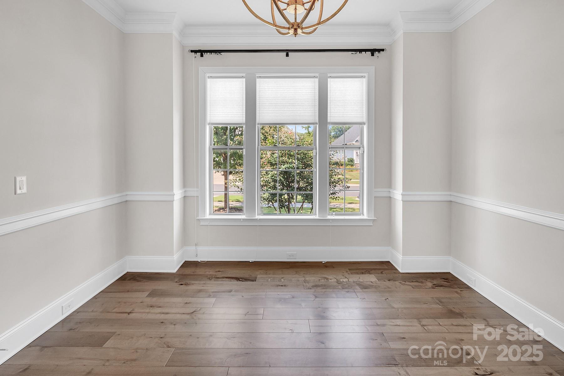14008 Little Spring Court Charlotte, NC 28278 - Photo 23 of 44 an empty room with wooden floor and windows