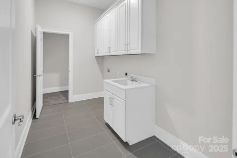 a utility room with cabinets washer and dryer