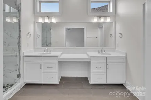 a bathroom with a sink vanity and mirror