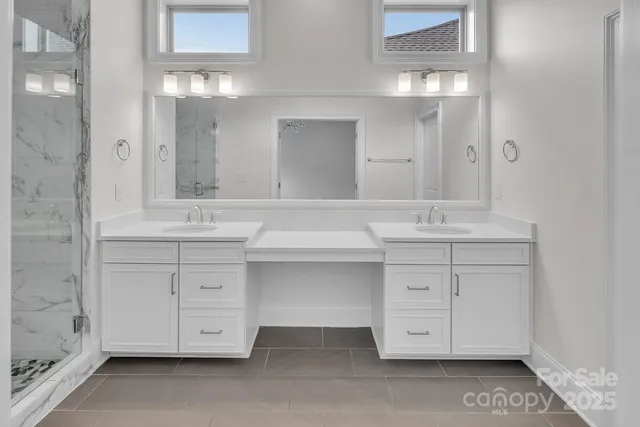 a bathroom with a sink vanity and mirror