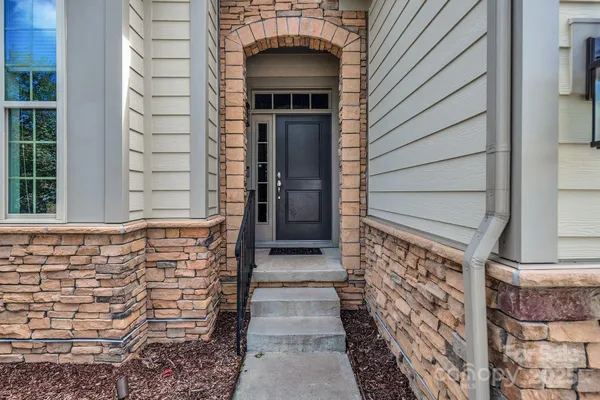 a view of front door of house with stairs
