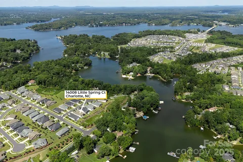an aerial view of residential houses with outdoor space and river