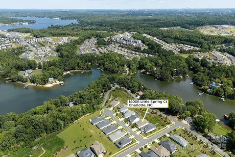 an aerial view of a house with a lake view