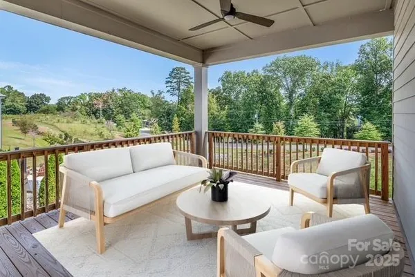 a balcony with furniture and a potted plant