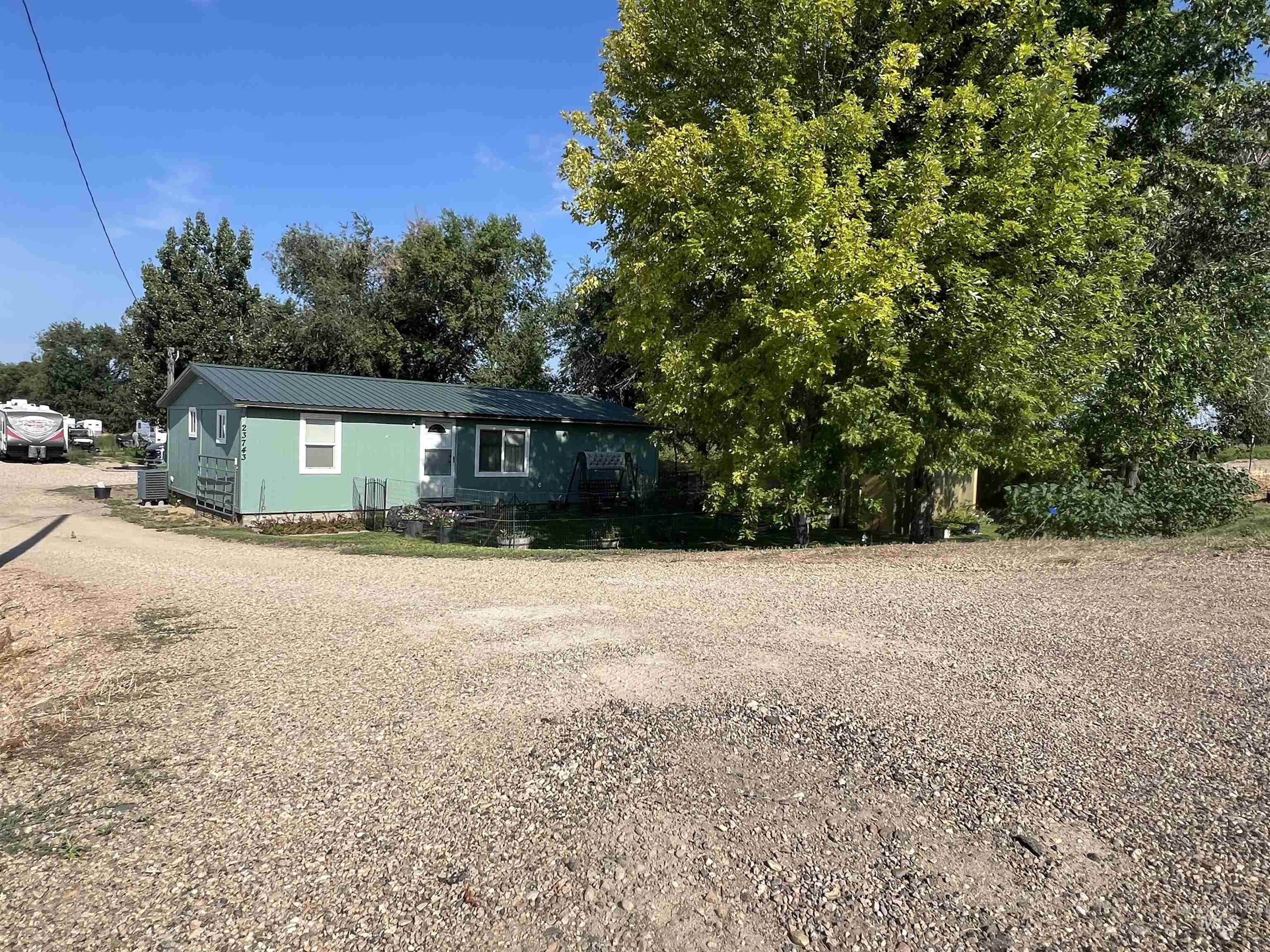 23743 Stephen Lane Parma, ID 83660 - Photo 20 of 34 View of front of home with a metal roof and driveway