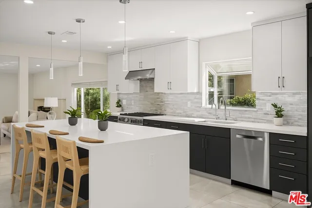 a kitchen with kitchen island granite countertop a sink a center island and cabinets