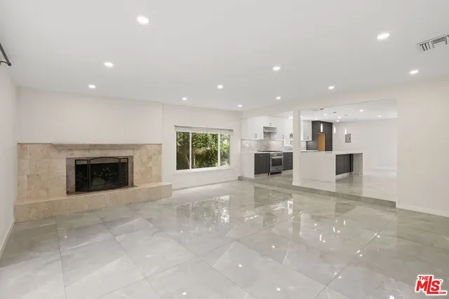 a view of a kitchen with a sink and a fireplace
