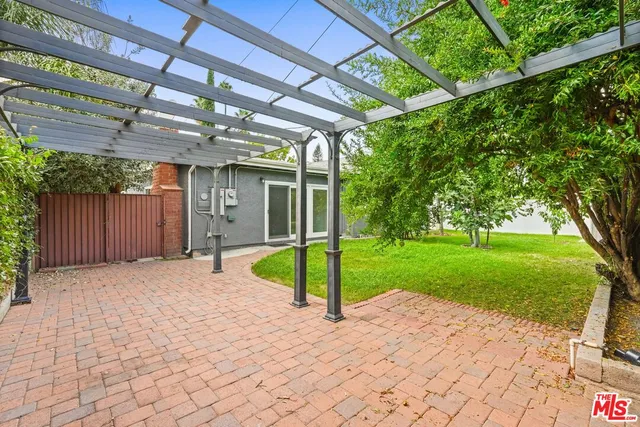 a view of a backyard with large trees