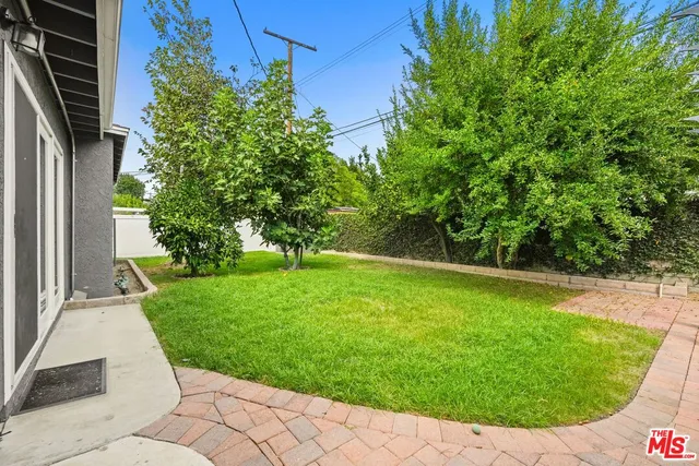 a view of a backyard with large trees