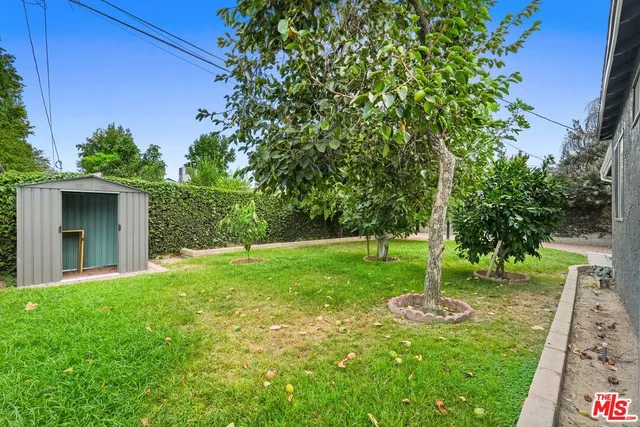 a view of a balcony with chairs and wooden fence