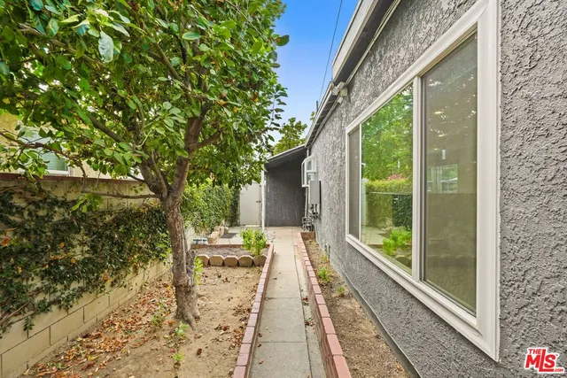 an aerial view of a house with a garden and a yard