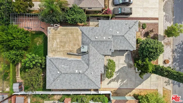 an aerial view of a house with outdoor space garden and tree s