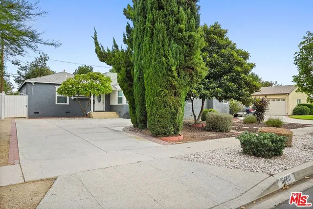 a front view of a house with a yard and a garage