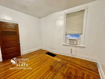 a view of a room with wooden floor and closet