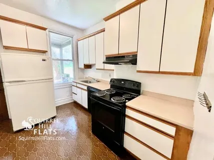 a kitchen with a refrigerator and a stove
