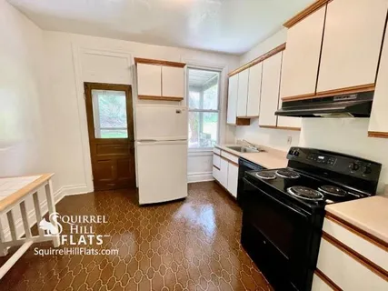 a kitchen with sink refrigerator and stove