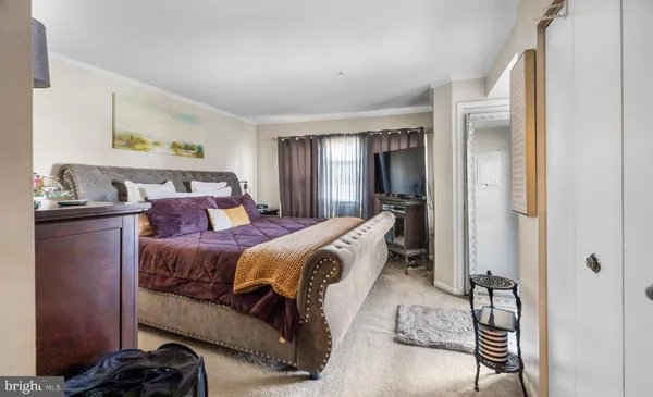 a bedroom with a bed and a mirror