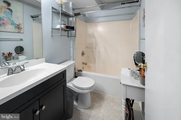 a bathroom with a sink toilet a mirror and shower